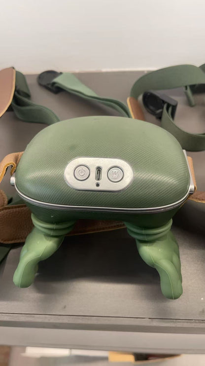 Green neck massager with straps on a metallic surface