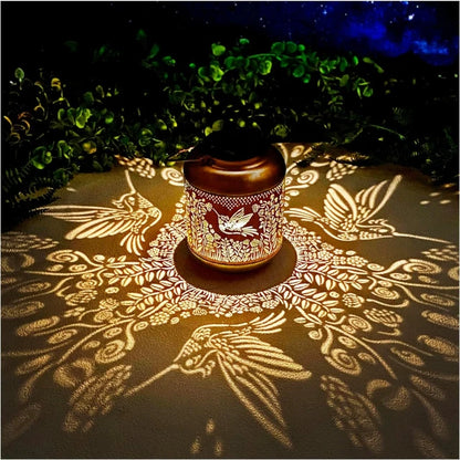 Decorative lantern casting floral shadows on a surface at night.