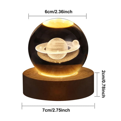 Decorative lamp with Saturn model on a wooden base, showing dimensions.