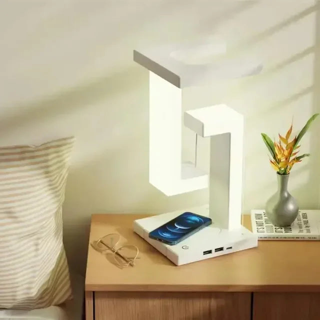 LevitaGlow anti-gravity LED desk lamp with wireless phone charging on a table.