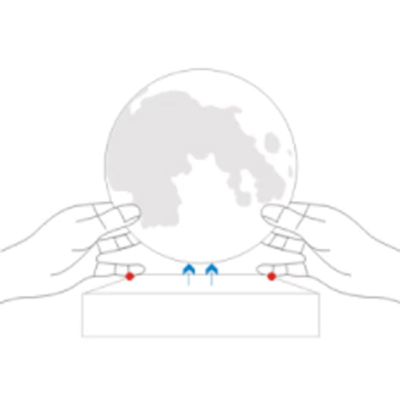 Diagram of a crystal moon lamp with hands holding it, showing points of contact.