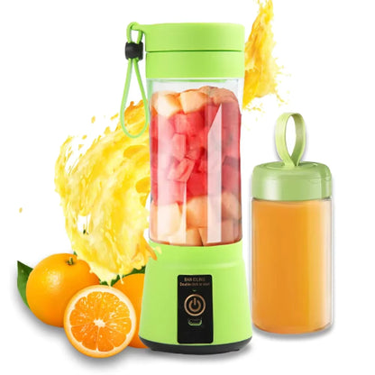 Green portable blender with fruits and a glass of juice on a white background