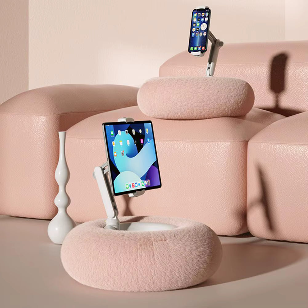 Pink cushioned phone stands with smartphones on a light pink background