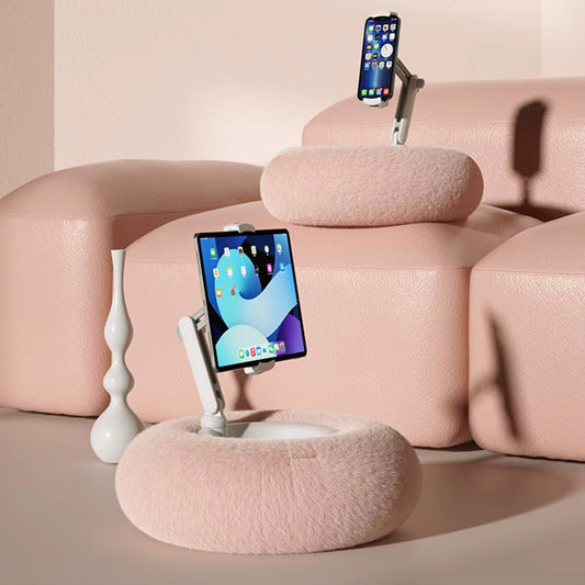 Pink cushioned phone stands with smartphones on a light pink background