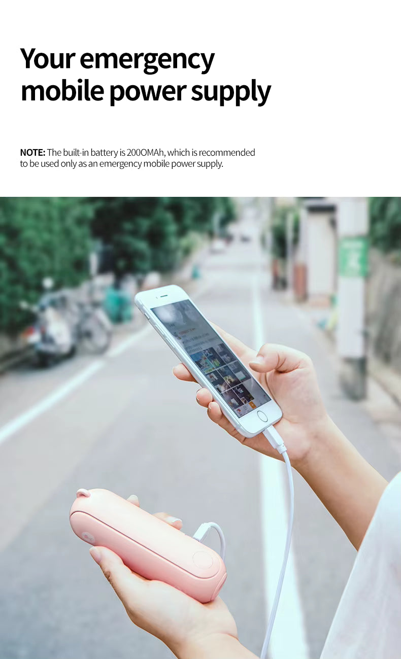 Person using a pink portable power bank to charge a smartphone on a street.