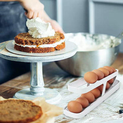 Baked goods on a stand with eggs in a holder on a kitchen counter