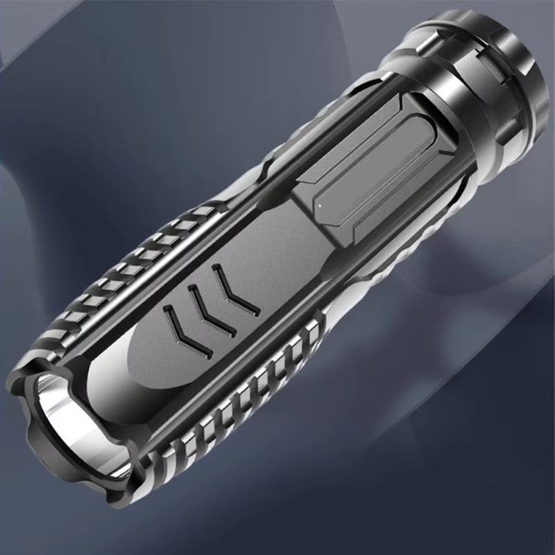 Metallic flashlight with textured grip on a dark background