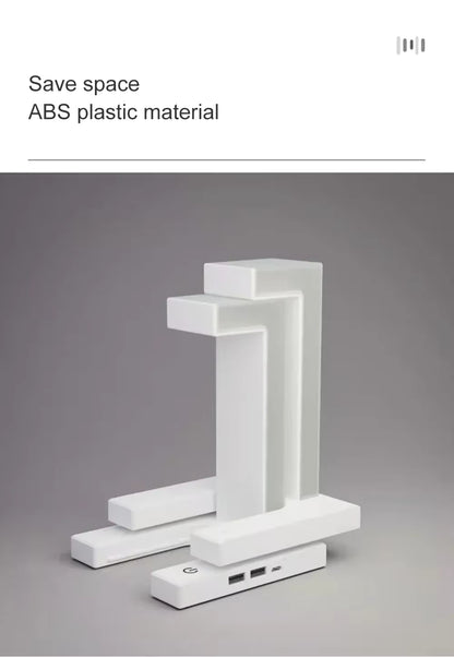 LevitaGlow anti-gravity LED desk lamp with wireless phone charging on a table.