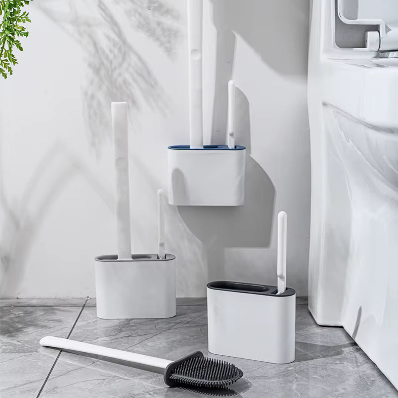 Bathroom cleaning tools including a toilet brush, scrubber, and holder on a tiled floor.