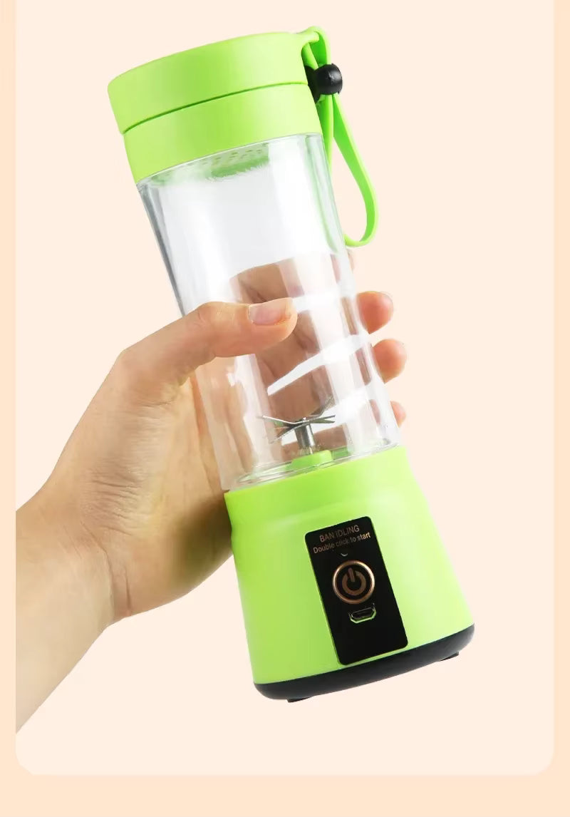 Hand holding a green portable blender on a beige background