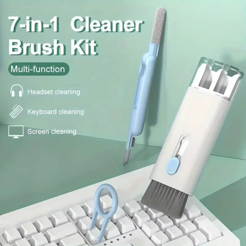 7-in-1 cleaner brush kit with various cleaning tools on a keyboard against a green background