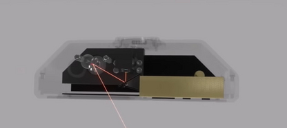 Close-up of a Photon Matrix interior with gears and a transparent casing on a gray background
