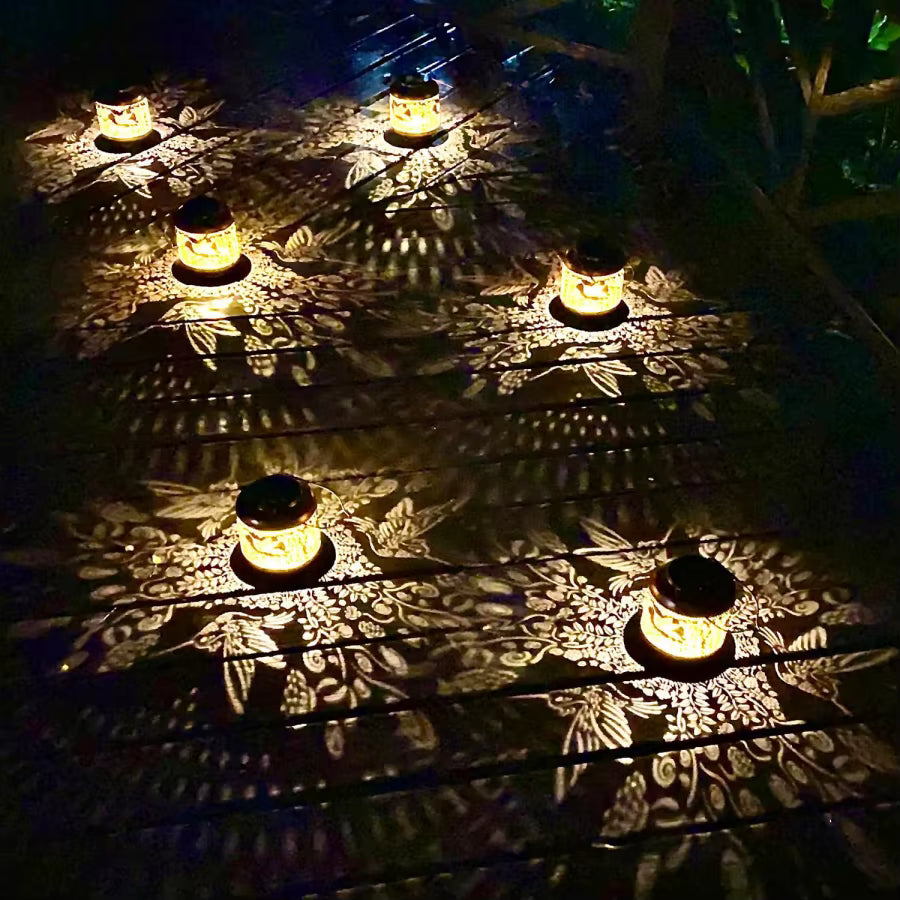 Decorative lights casting shadows on a textured surface at night