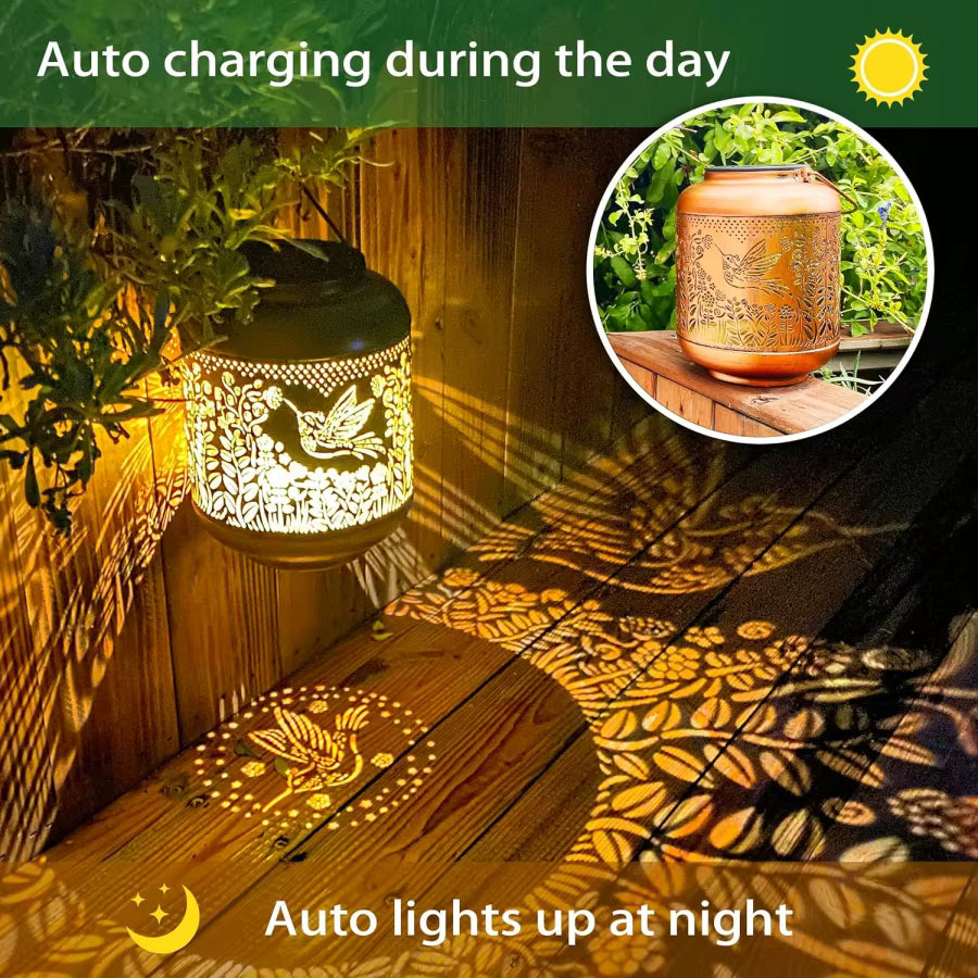 Decorative lantern with cut-out designs casting shadows on a wooden surface, with text indicating auto charging during the day and auto lighting up at night.