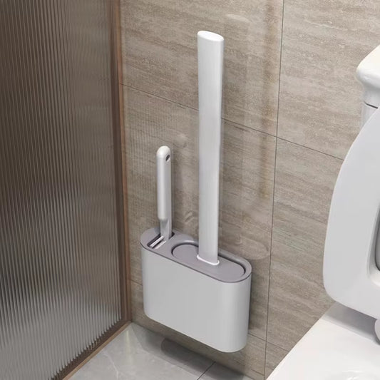 White toilet brush and holder mounted on a bathroom wall.