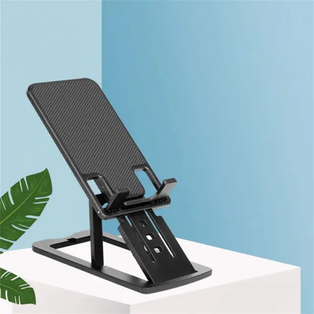 Black adjustable phone stand on a white surface with a blue background