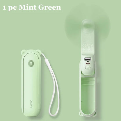 Mint green electronic device with a strap on a light green background