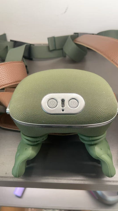 Green electronic neck massager with buttons on a metal surface