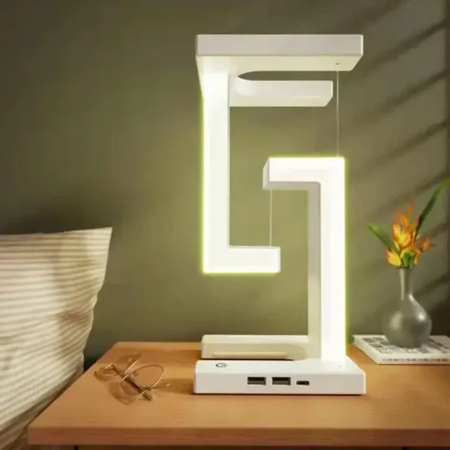 LevitaGlow anti-gravity LED desk lamp with wireless phone charging on a table.